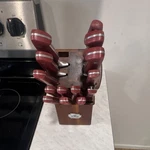 Pd 12-PIECE Stainless Steel Block Set With Red Composite Handles & Wooden Stand. Fixed Price $18.00.